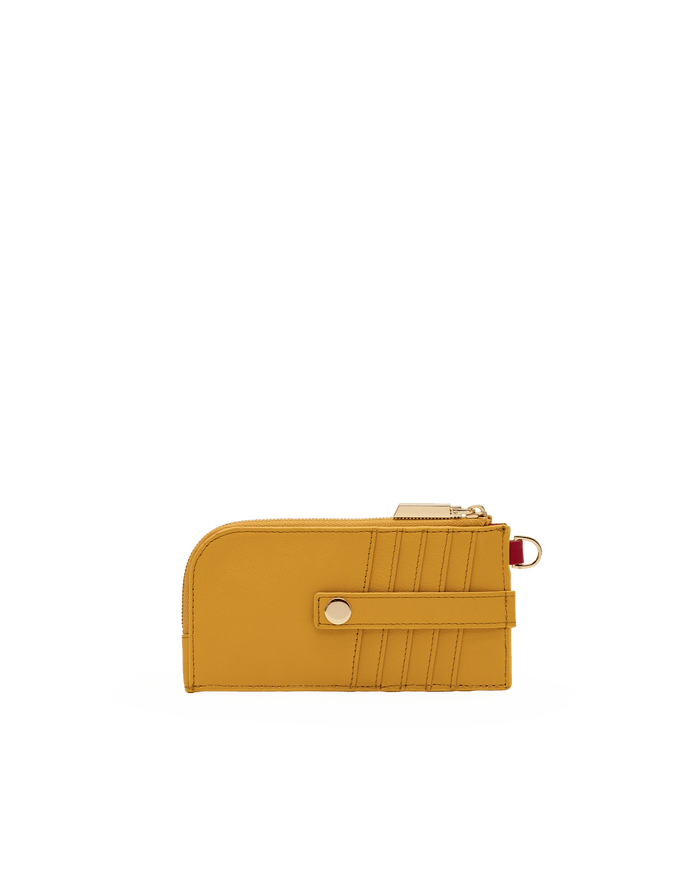 A mustard yellow leather zip-around card holder wallet with a gold-tone snap button and a small red accent ring, shown on a plain white background.