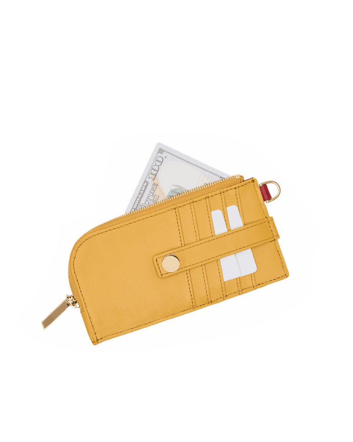 A yellow leather zip-around wallet with gold-tone hardware, shown with a dollar bill partially tucked inside on a plain white background.