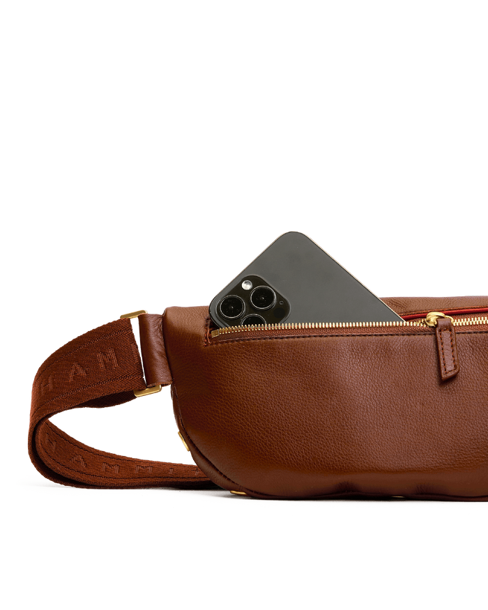 Brown leather waist bag with a phone pocket on a white background