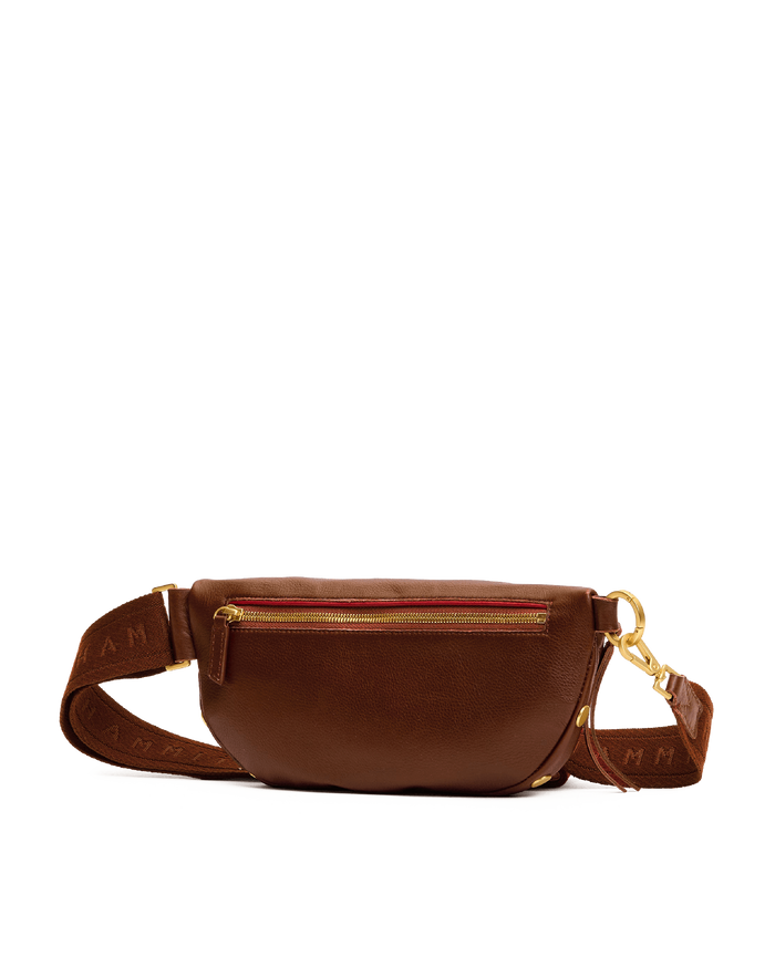 Brown leather fanny pack with gold zippers on a white background
