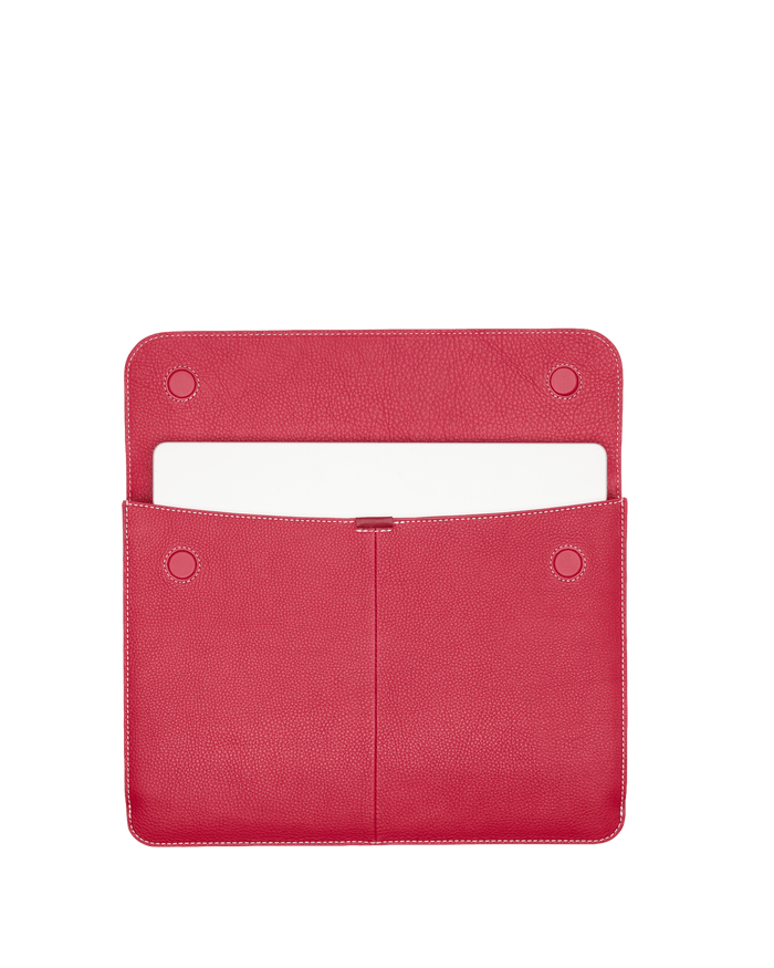Red pouch with a white item inside on a black background