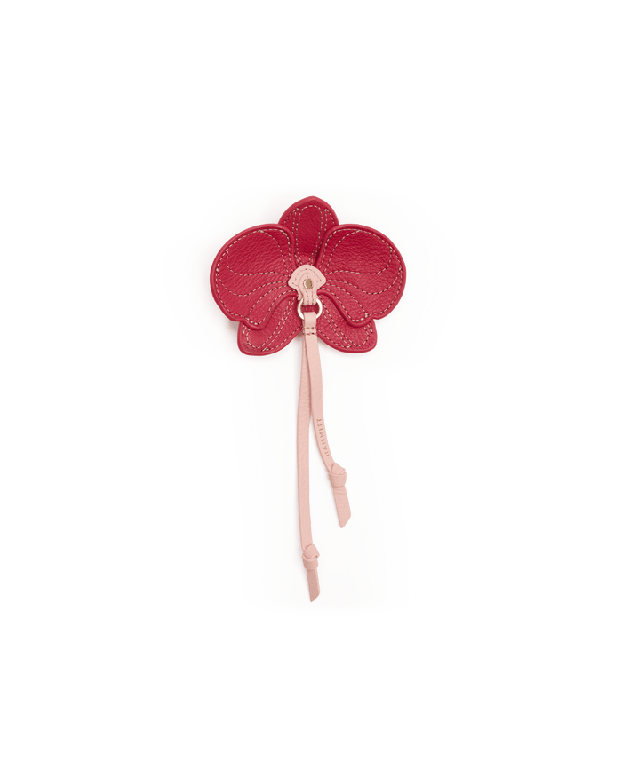 White golf head cover with a red orchid design on a black background