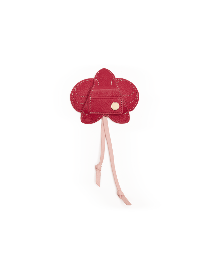 Red flower-shaped object on a white background