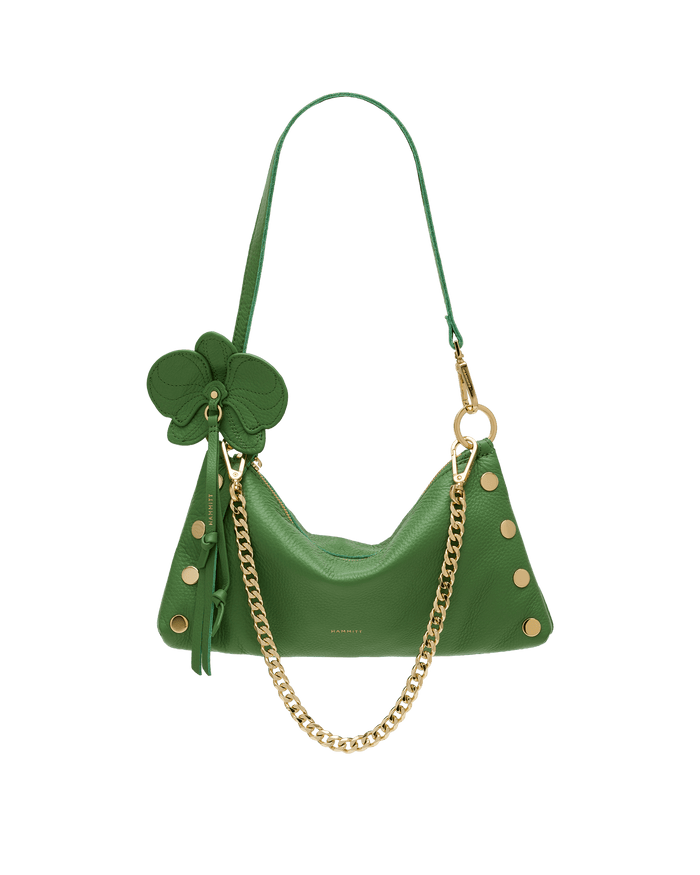 Green handbag with gold chain and decorative bow on a black background