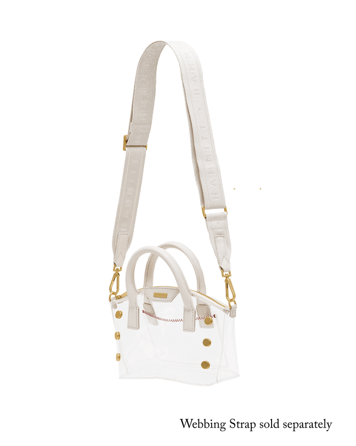 A white structured handbag with double top handles, a long matching shoulder strap, and gold-tone hardware.