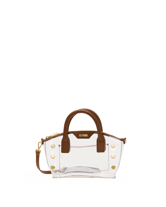 A clear vinyl handbag with brown faux-leather handles and trim, accented by gold-tone studs.