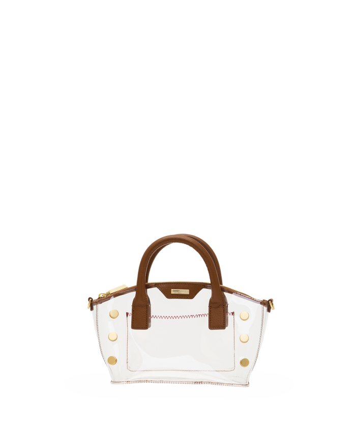 A clear vinyl handbag with brown leather handles and trim, accented by gold-tone hardware and a zippered top.