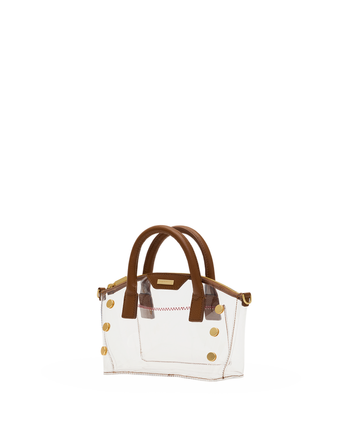 A small structured handbag with a clear transparent body, brown leather handles and trim, and gold-tone hardware.