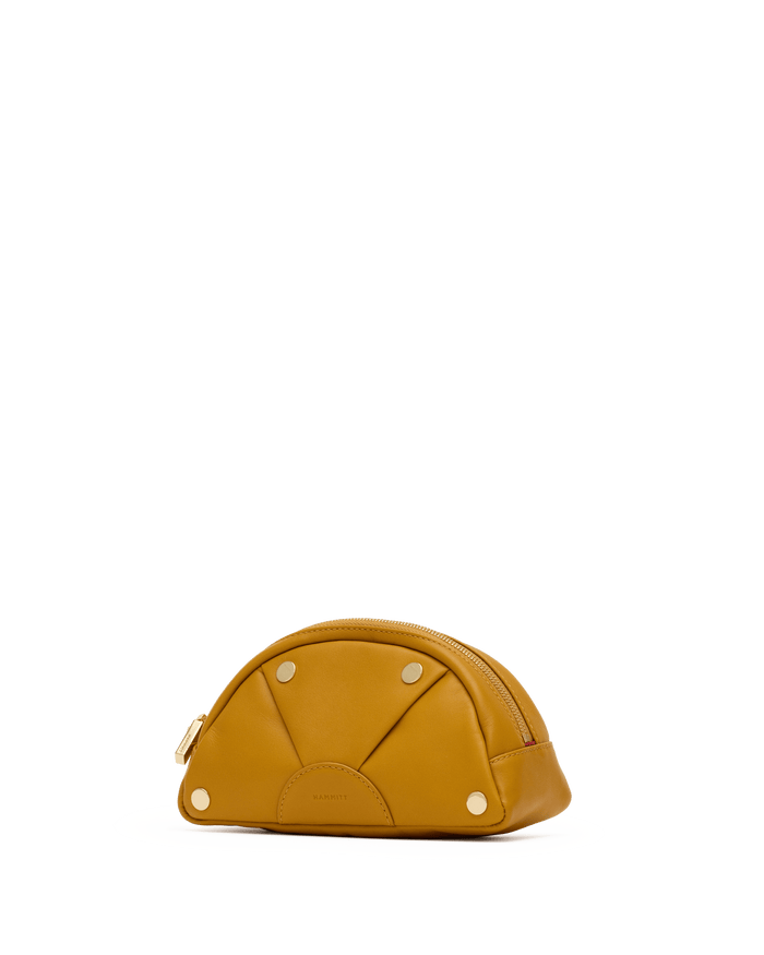 Yellow dome-shaped bag on a white platform with a black background