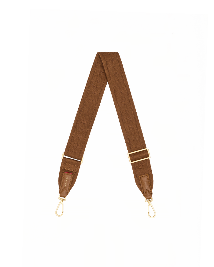 A brown fabric shoulder strap with gold-tone metal hardware, including swivel clips and adjustment sliders, laid out in a V-shape.